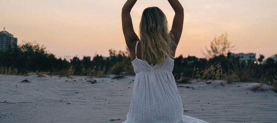 Silhouette of a person meditating at sunset.